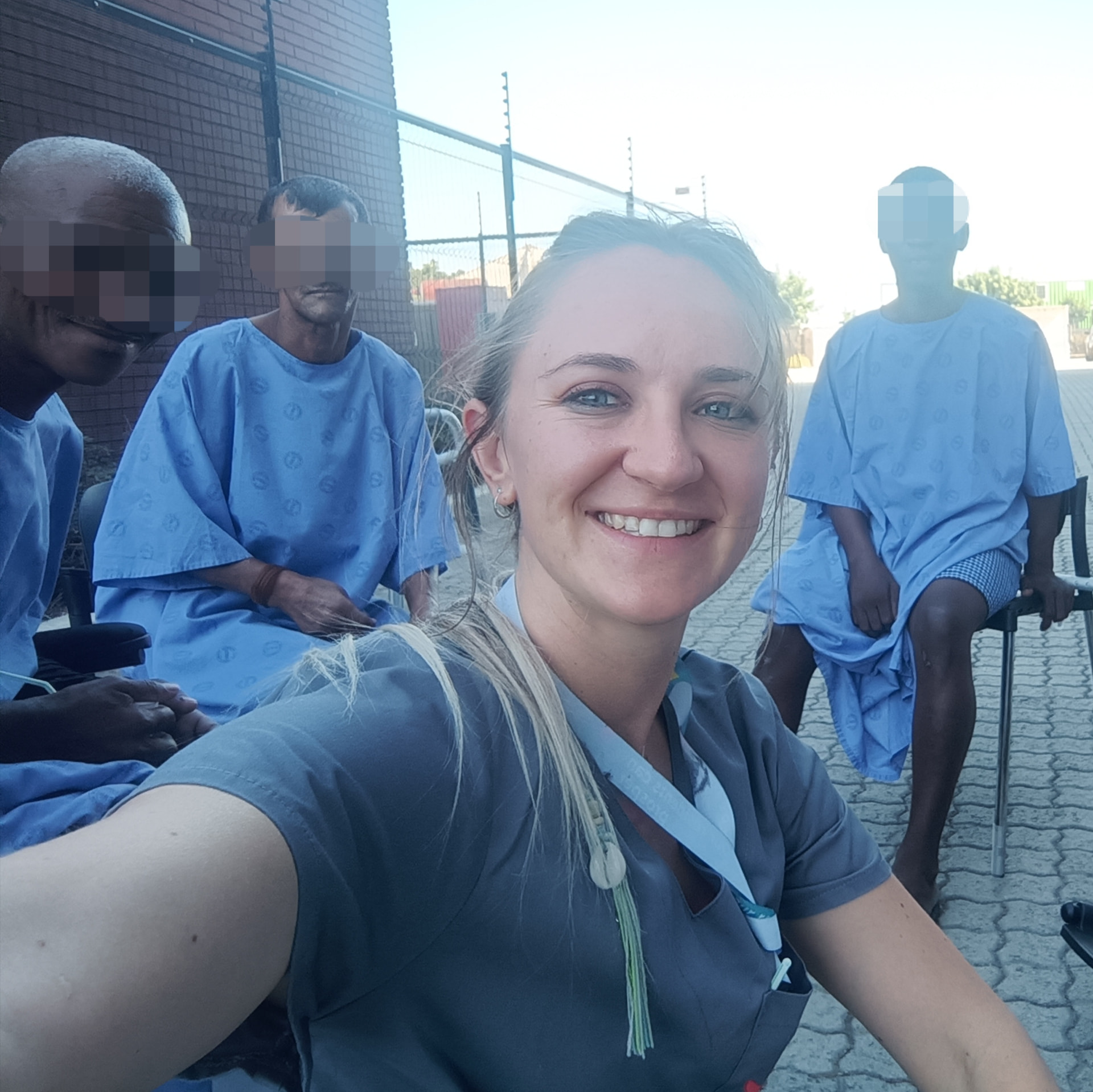 Alicia with patients during her work in an acute hospital setting