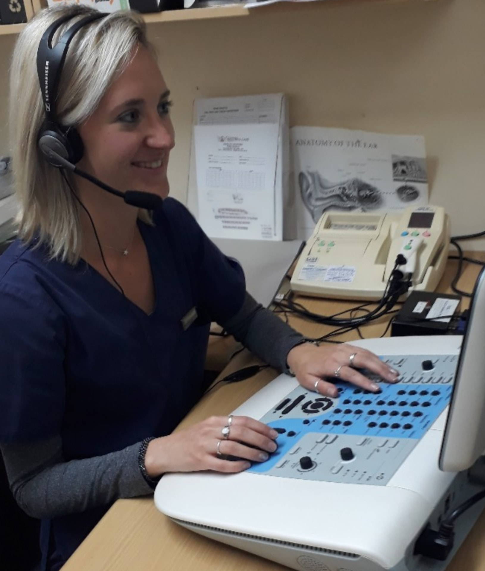 Alicia conducting a hearing assessment in a clinical setting